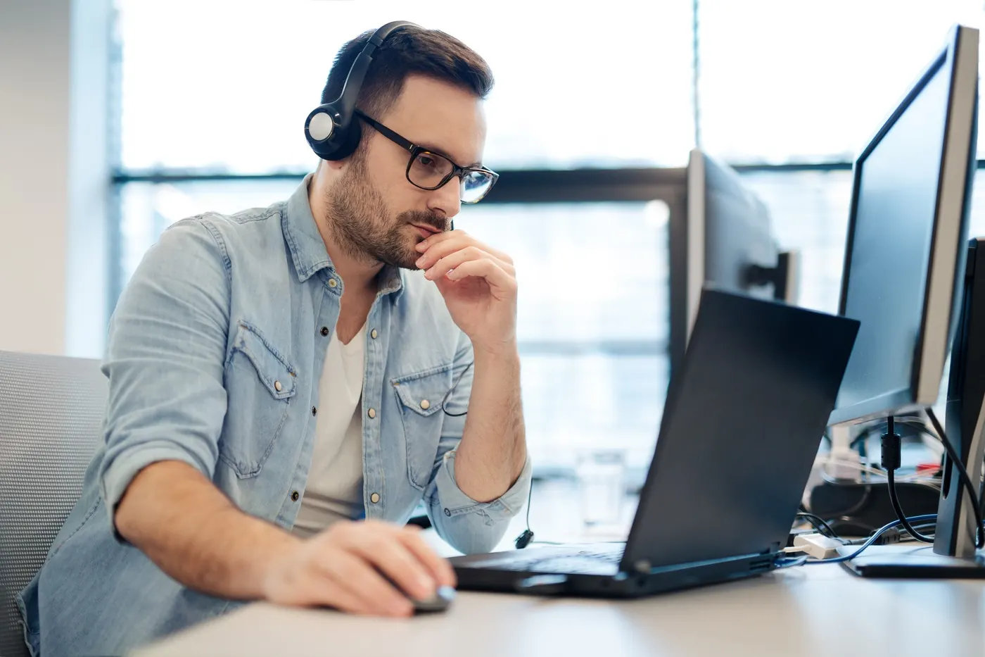 A volunteer working at a computer providing technology support